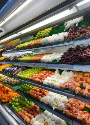 Vibrant assortment of fresh fruits neatly arranged in a grocery store display.